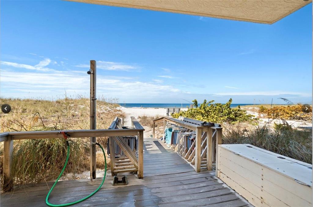 13440 Gulf Lane, Unit 202 Madeira Beach, FL 33708 - Photo 27 of 41 a view of a balcony with chairs and wooden floor