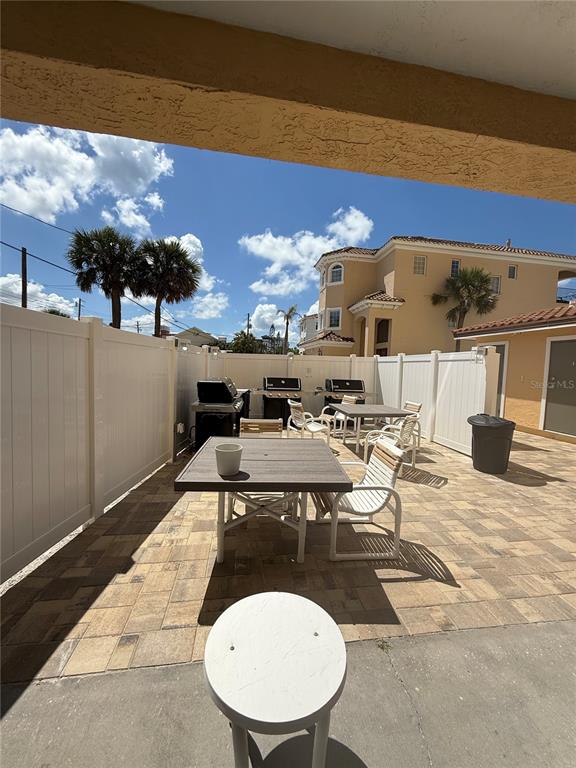 13440 Gulf Lane, Unit 202 Madeira Beach, FL 33708 - Photo 32 of 41 a view of a patio with swimming pool table and chairs