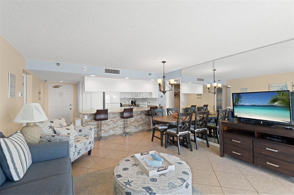 13440 Gulf Lane, Unit 202 Madeira Beach, FL 33708 - Photo 8 of 41 a living room with furniture and a flat screen tv