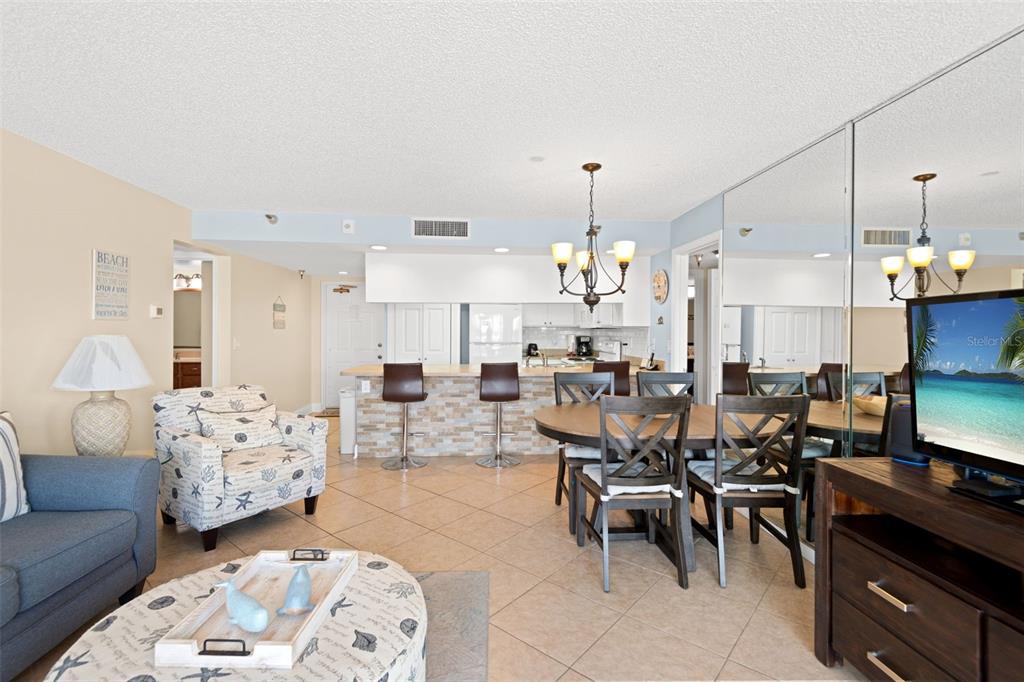 13440 Gulf Lane, Unit 202 Madeira Beach, FL 33708 - Photo 10 of 41 a living room with lots of furniture and kitchen view