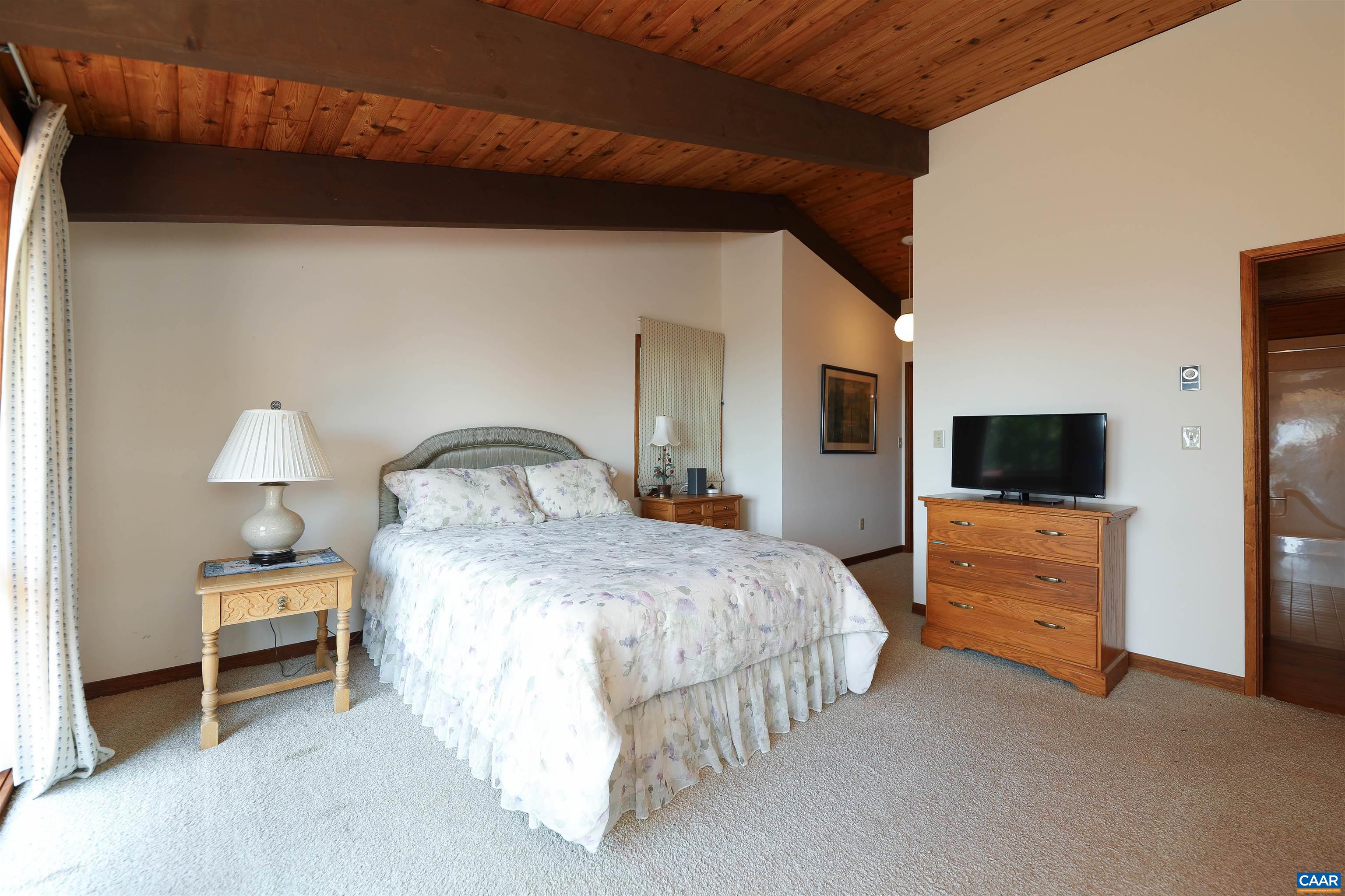 383 Cedar Drive Wintergreen, VA 22967 - Photo 24 of 47 a bedroom with a bed and a television