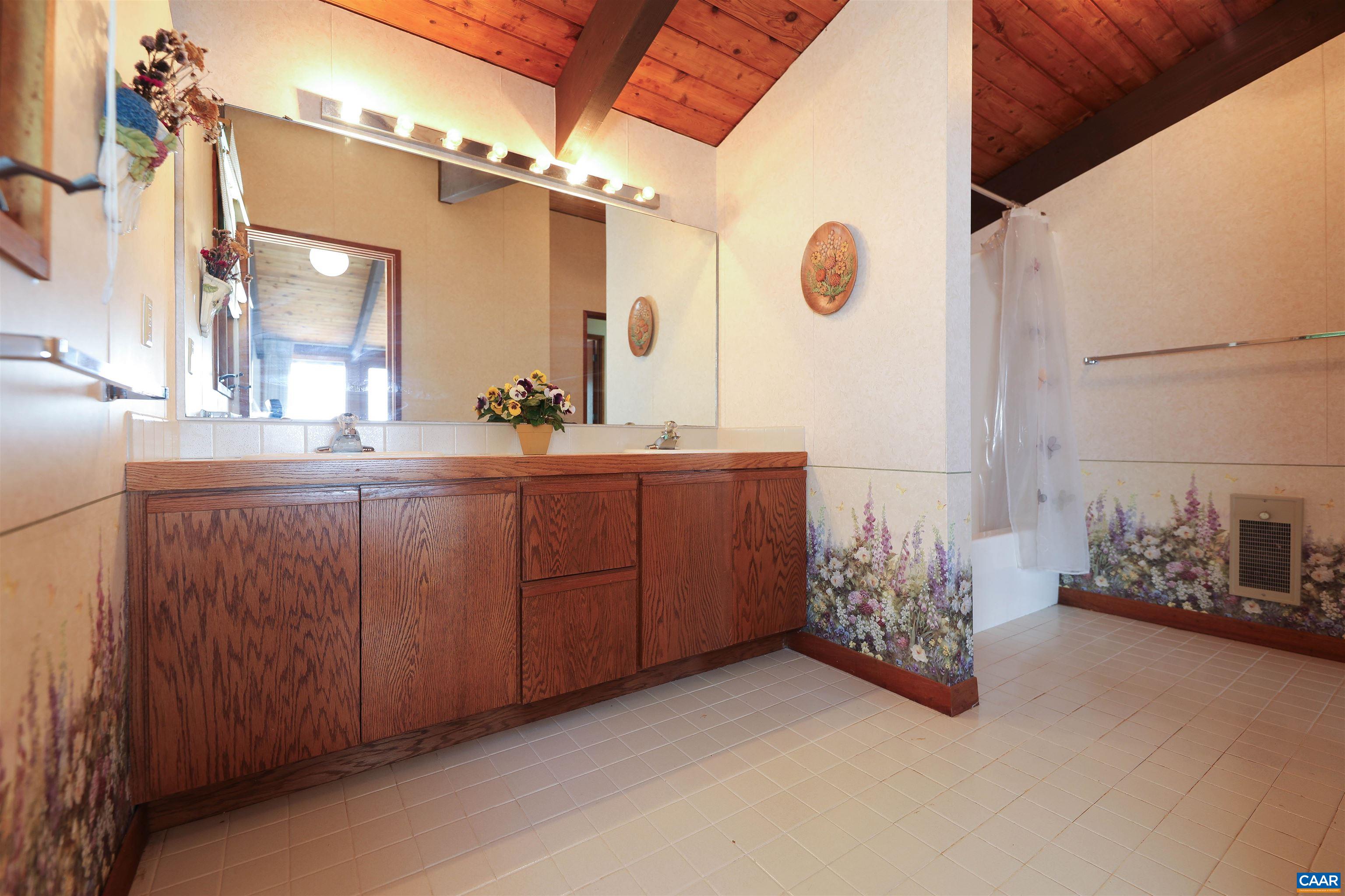 383 Cedar Drive Wintergreen, VA 22967 - Photo 27 of 47 a bathroom with double vanity and a mirror