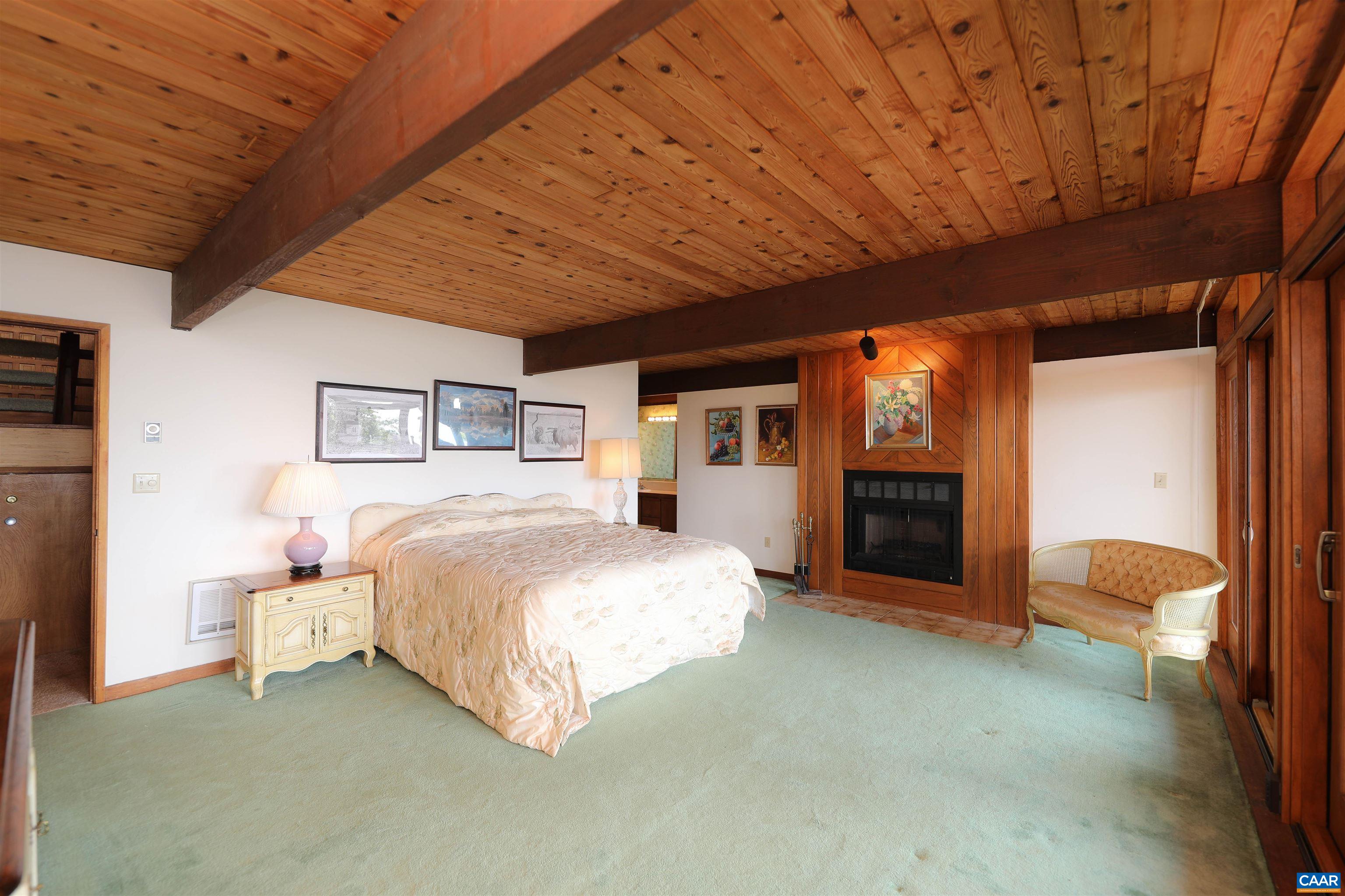 383 Cedar Drive Wintergreen, VA 22967 - Photo 32 of 47 a spacious bedroom with a bed and a view of bathroom