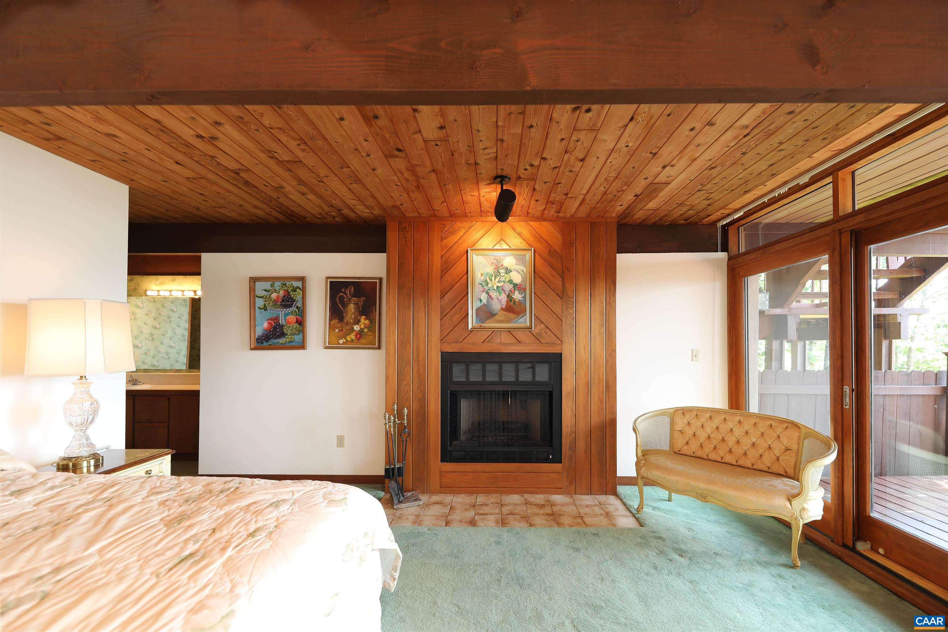 383 Cedar Drive Wintergreen, VA 22967 - Photo 36 of 47 a bedroom with a bed and a dresser next to a window