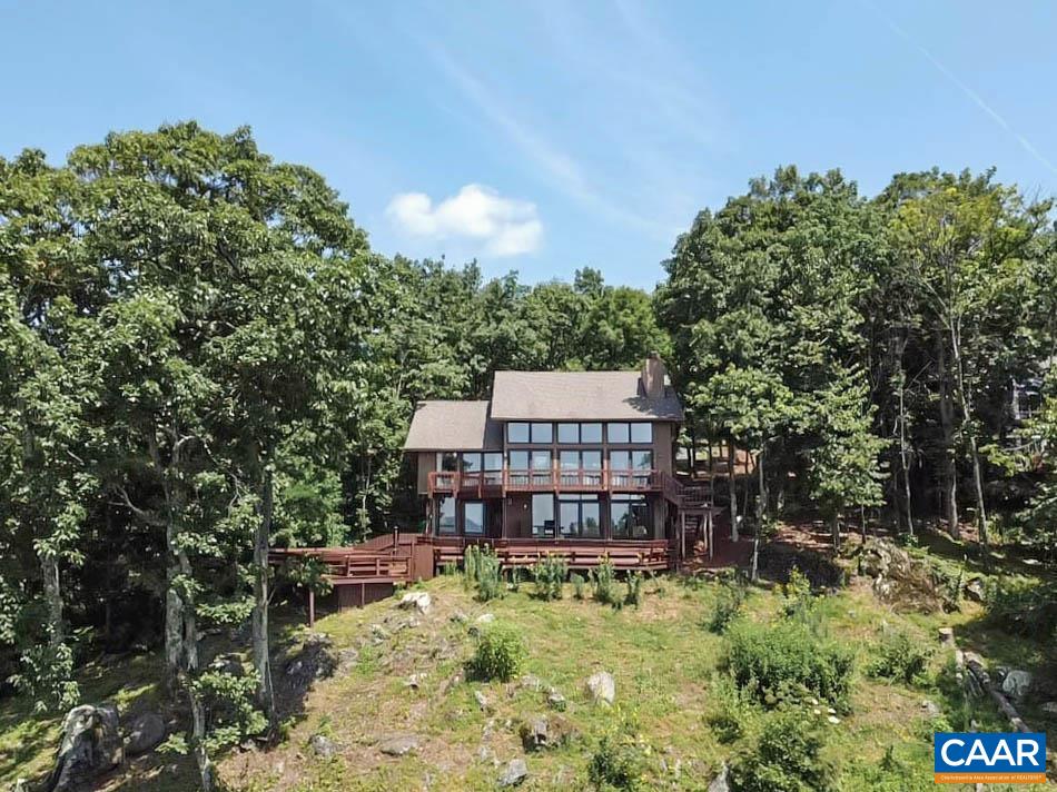 383 Cedar Drive Wintergreen, VA 22967 - Photo 41 of 47 a backyard of a house with large trees and plants