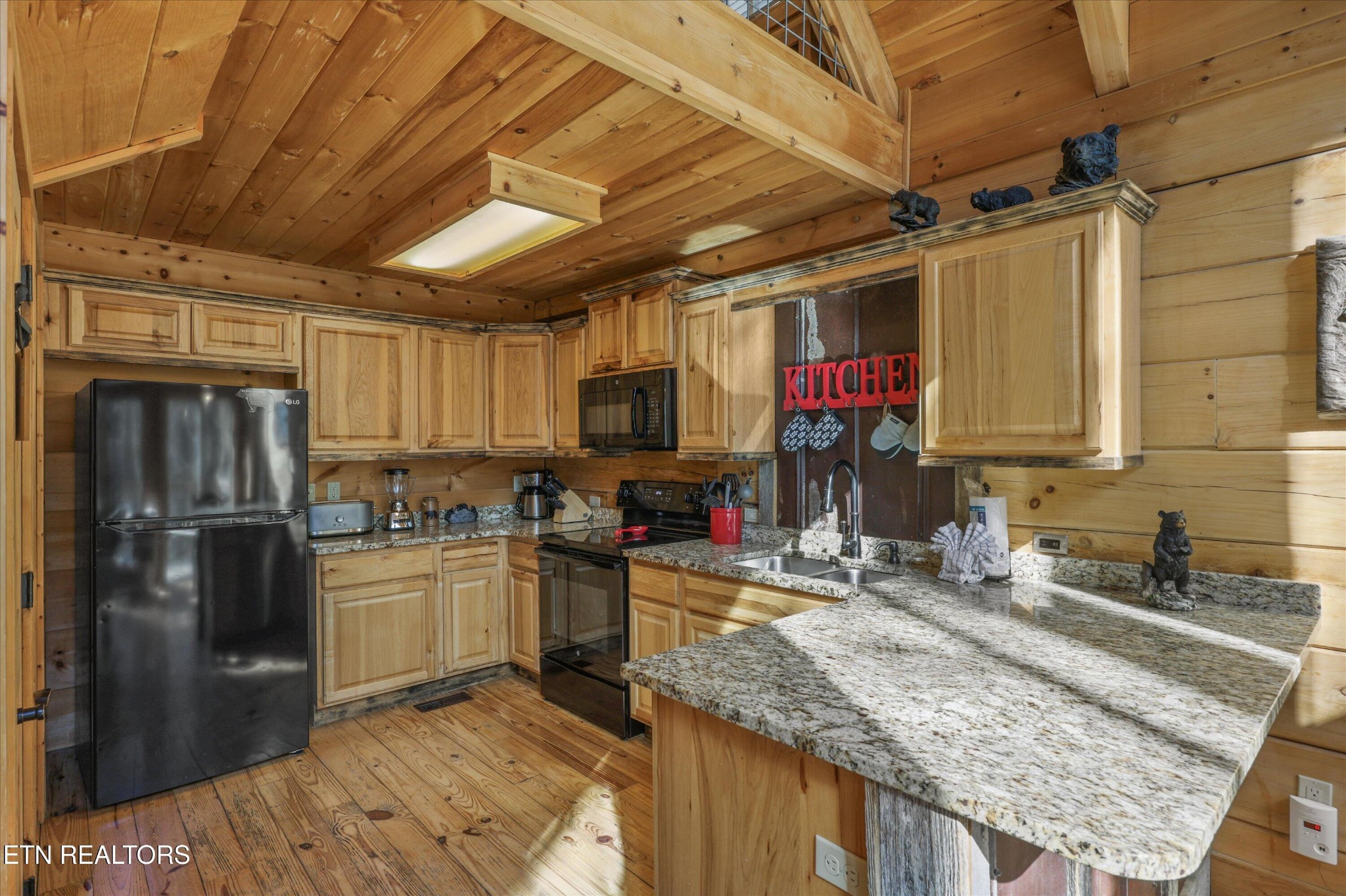 253 Cartertown Road Gatlinburg, TN 37738 - Photo 11 of 30 a kitchen with stainless steel appliances granite countertop a sink stove and refrigerator