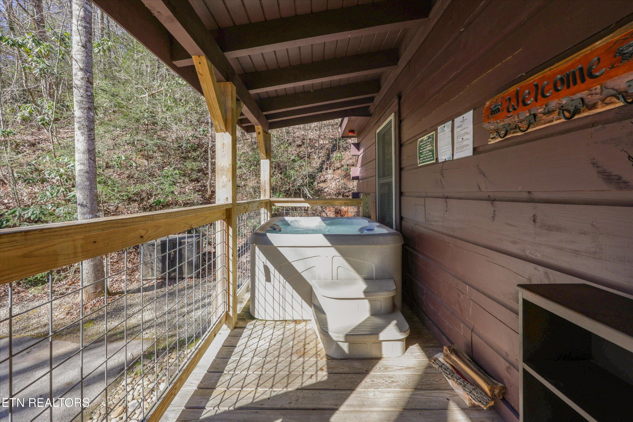 253 Cartertown Road Gatlinburg, TN 37738 - Photo 25 of 30 a balcony with wooden floor and furniture