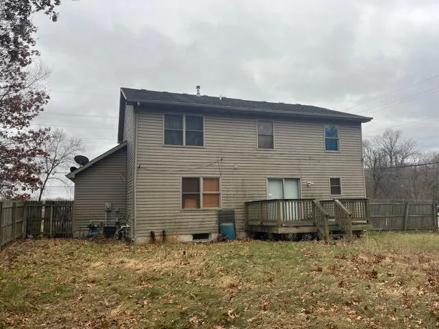 a living room with furniture and a air conditioner vent