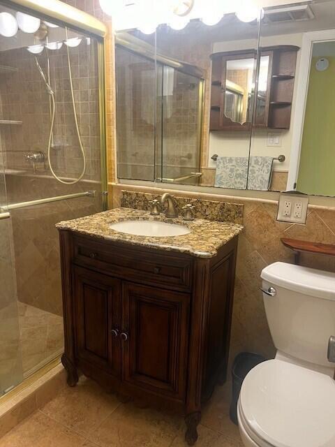 132 South Cypress Road, Unit 523 Pompano Beach, FL 33060 - Photo 17 of 25 a bathroom with a granite countertop sink a toilet and a mirror