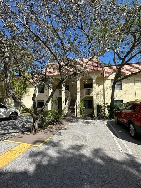 132 South Cypress Road, Unit 523 Pompano Beach, FL 33060 - Photo 2 of 25 a view of a car park in front of house