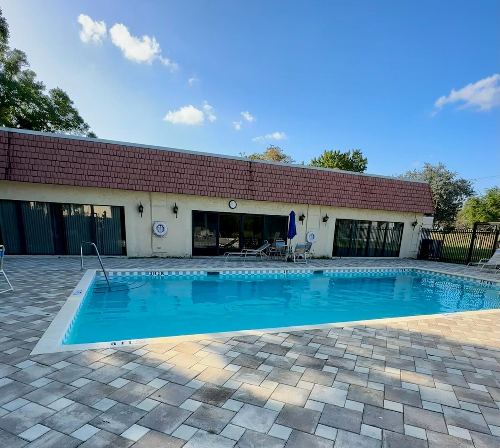 132 South Cypress Road, Unit 523 Pompano Beach, FL 33060 - Photo 23 of 25 a view of a house with a swimming pool