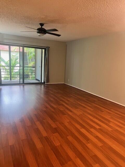 132 South Cypress Road, Unit 523 Pompano Beach, FL 33060 - Photo 9 of 25 a view of room with wooden floor and fan