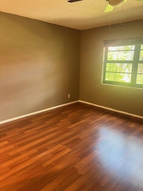 132 South Cypress Road, Unit 523 Pompano Beach, FL 33060 - Photo 10 of 25 a view of an empty room with wooden floor and a window