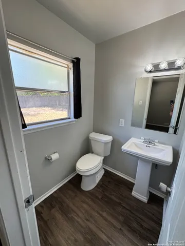 a bathroom with a toilet sink and mirror