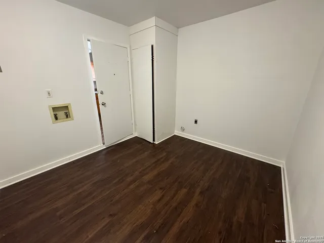 an empty room with wooden floor
