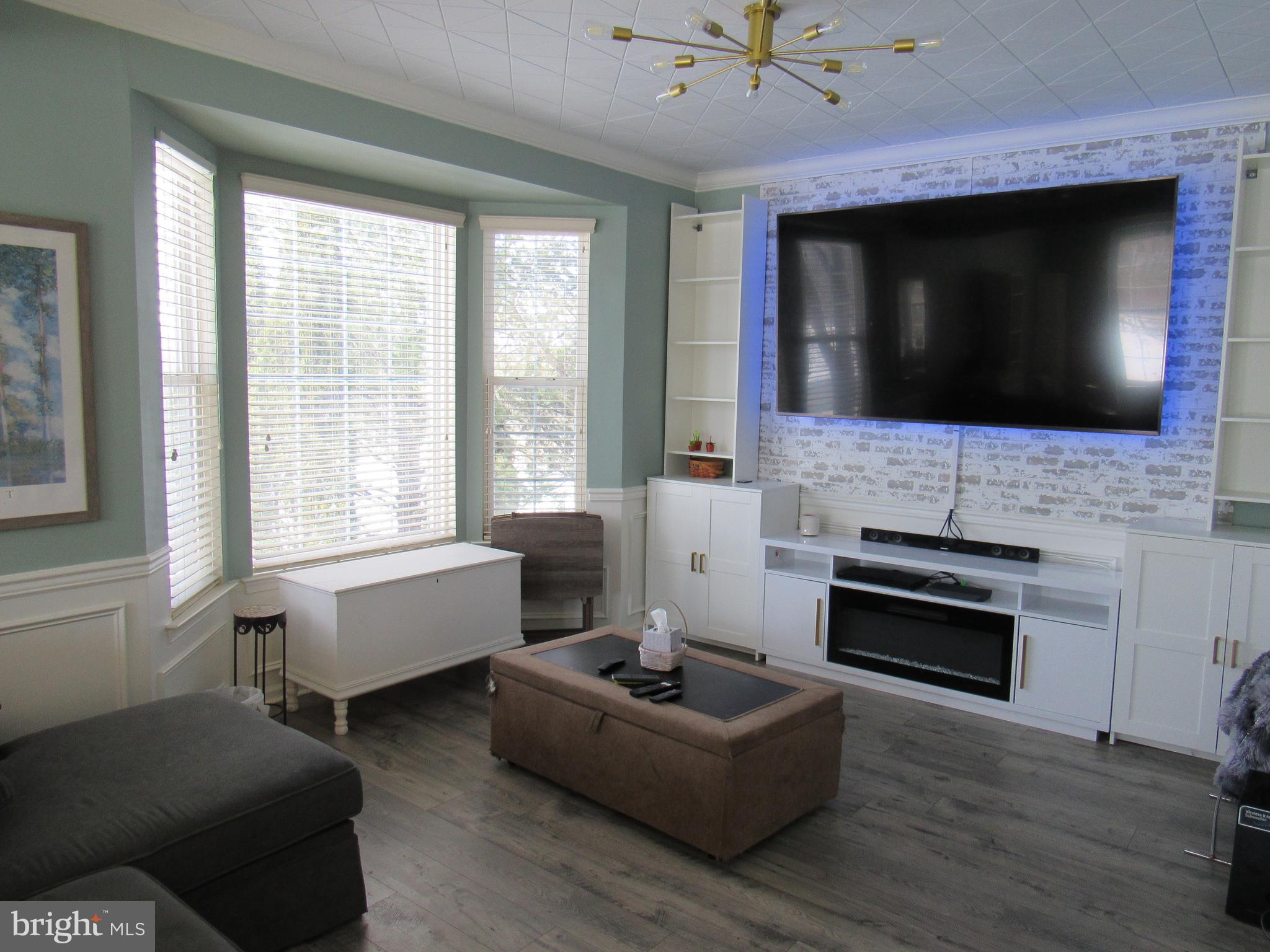 17 Wilt Road Bechtelsville, PA 19505 - Photo 9 of 31 a living room with furniture a flat screen tv and a fireplace