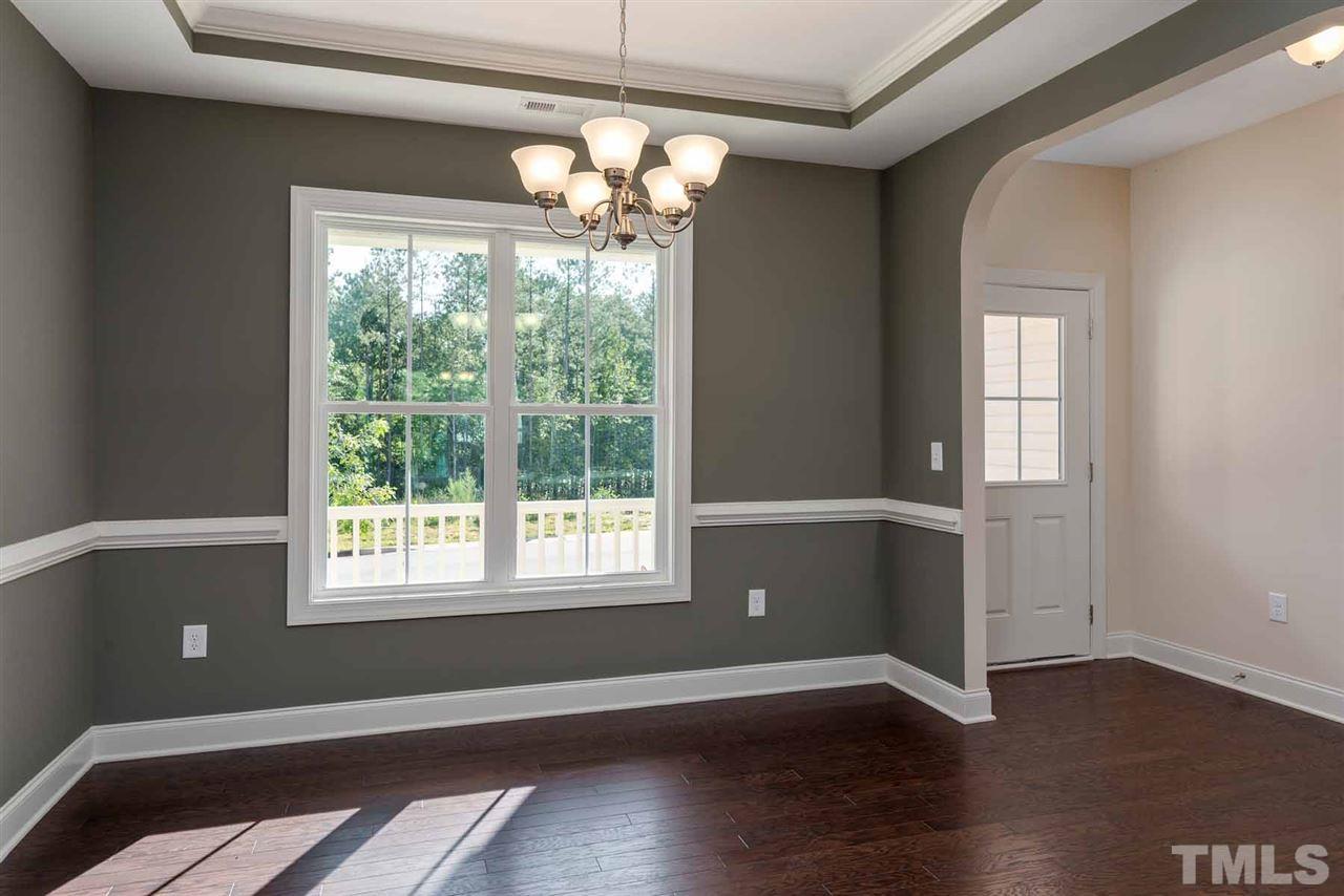 7208 Cornett Way Raleigh, NC 27604 - Photo 4 of 4 a view of an empty room with wooden floor and a window