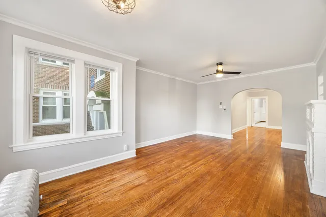 a view of empty room with wooden floor