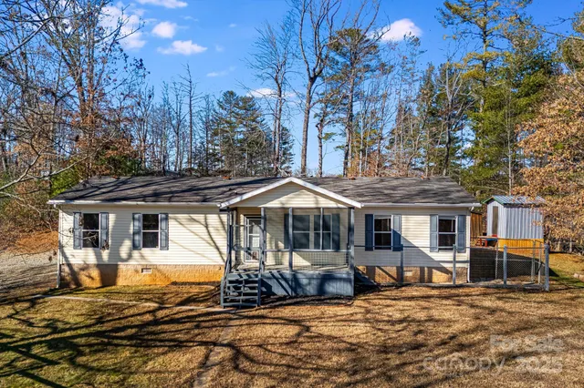 a view of a patio with a large tree next to a yard