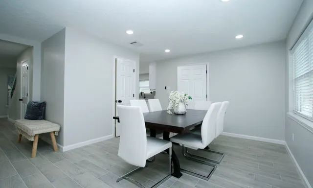 a view of a dining room with furniture and wooden floor