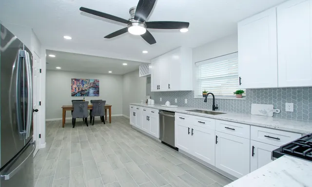 a kitchen with a sink cabinets and window