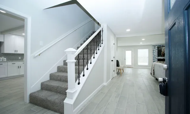 a view of entryway and hall with wooden floor