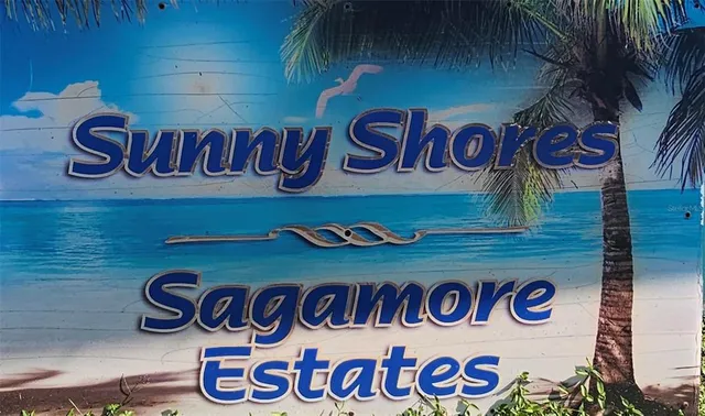 a view of a kitchen with wooden floor electronic appliances and windows