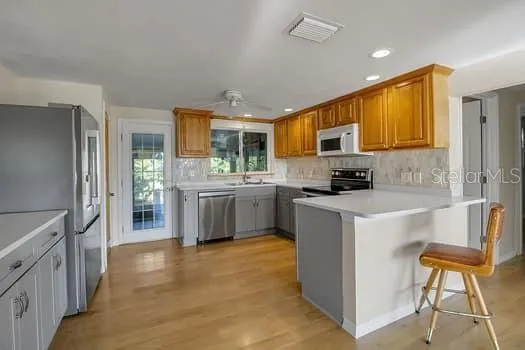 a kitchen with stainless steel appliances a stove sink and cabinets