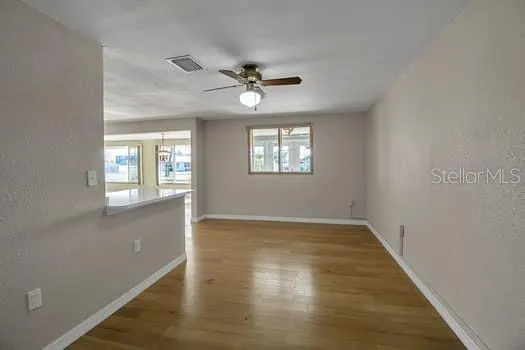 wooden floor in an empty room with a window