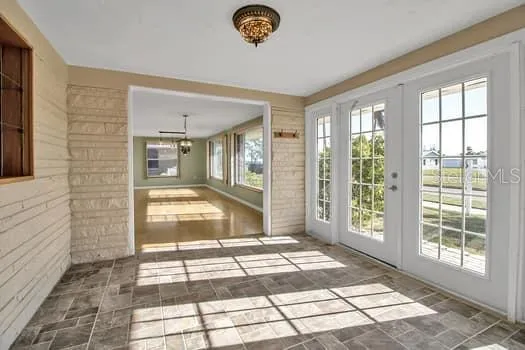 a kitchen with white cabinets and a window