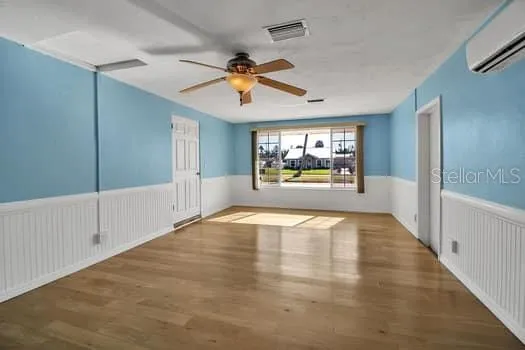 a view of a room with wooden floor and windows