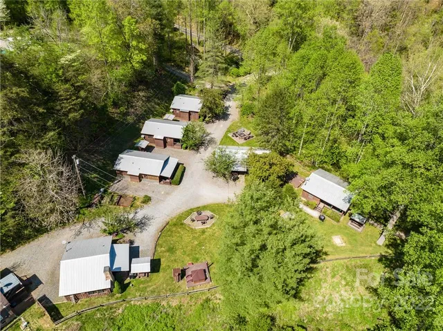 an aerial view of residential house with swimming pool and garden space