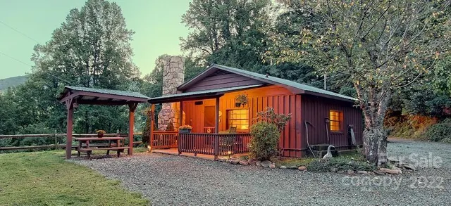 a backyard of a house with barbeque oven table and chairs