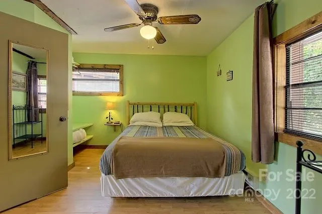 a bedroom with a bed dresser and a window