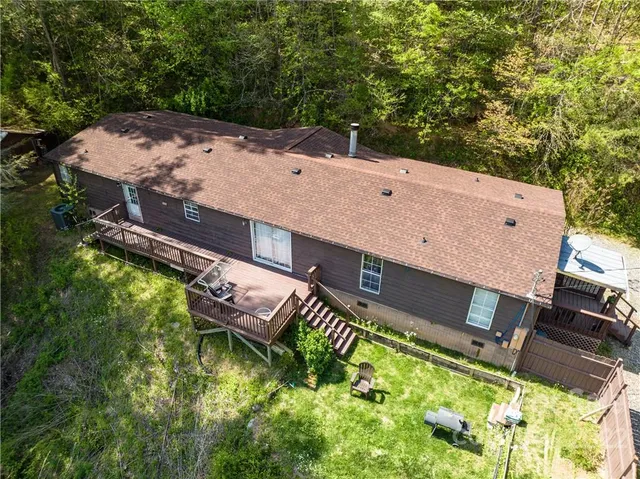 an aerial view of a house with a yard fountain fire pit and outdoor seating