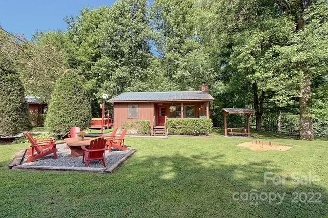 a dining room with furniture a fireplace and wooden floor