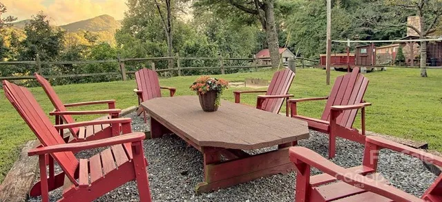 a view of a deck with couches chairs and wooden floor