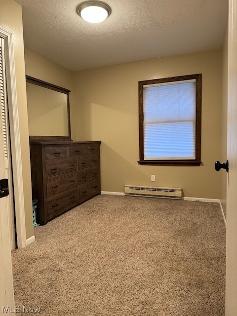 8274 Ruff Road West Salem, OH 44287 - Photo 18 of 30 Carpeted empty room featuring a baseboard heating unit and a textured ceiling