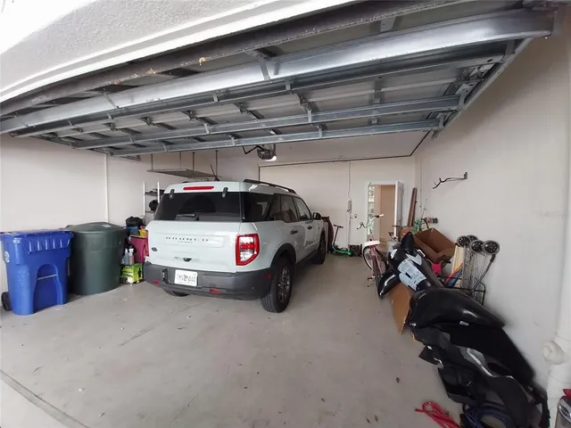 a living room with furniture a flat screen tv and a window