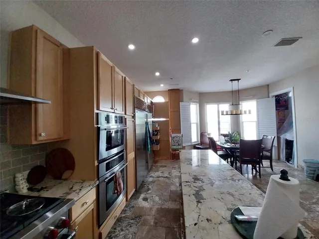 a kitchen with granite countertop stainless steel appliances lots of counter top space