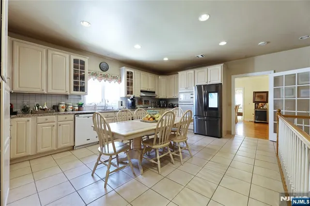 a kitchen with cabinets and chairs
