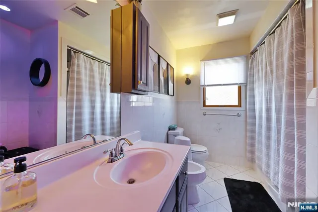 a kitchen with stainless steel appliances kitchen island granite countertop a table chairs and a refrigerator