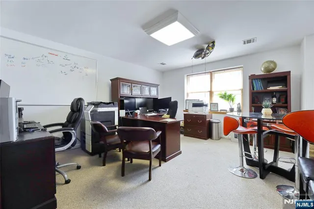 a living room with furniture a air conditioner vent and a window