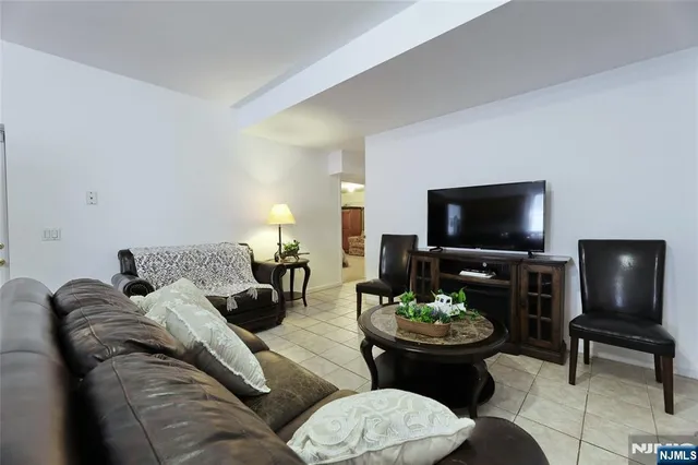 a open dining room with kitchen island granite countertop a sink table and chairs