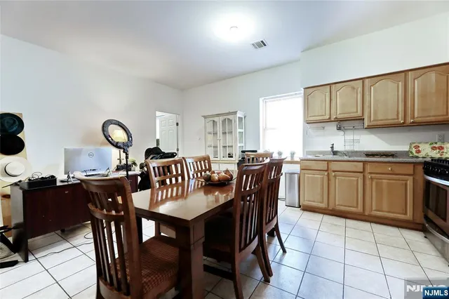 a bedroom with bed couches and a flat tv screen