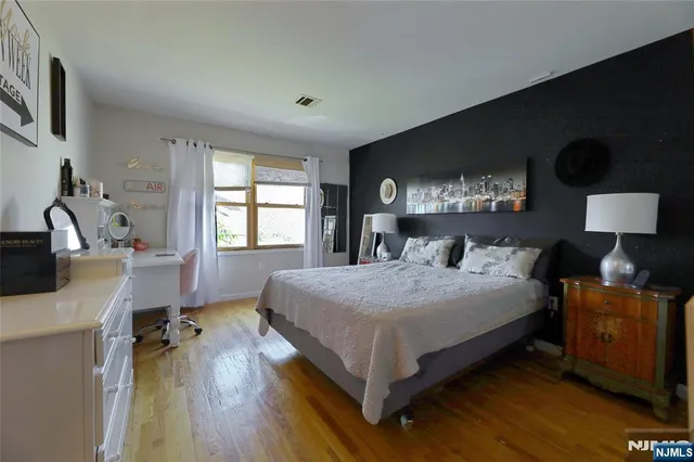 a spacious bedroom with a bed and a table in it