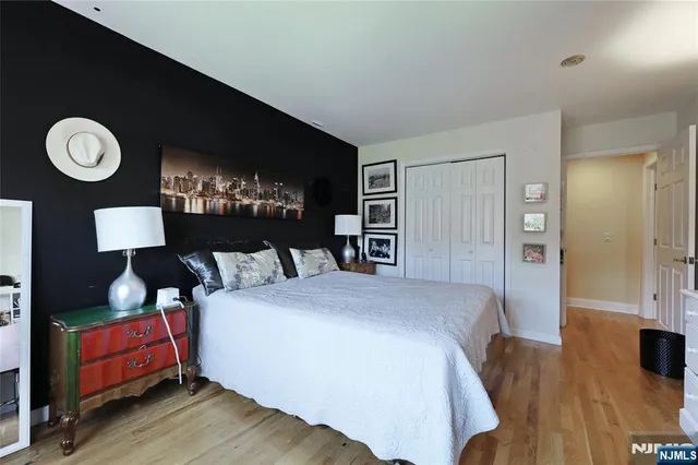 a living room with furniture a wooden floor and a window