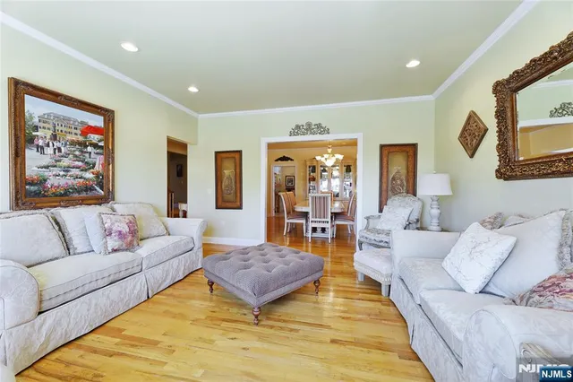 a view of a dining room with furniture a chandelier and wooden floor