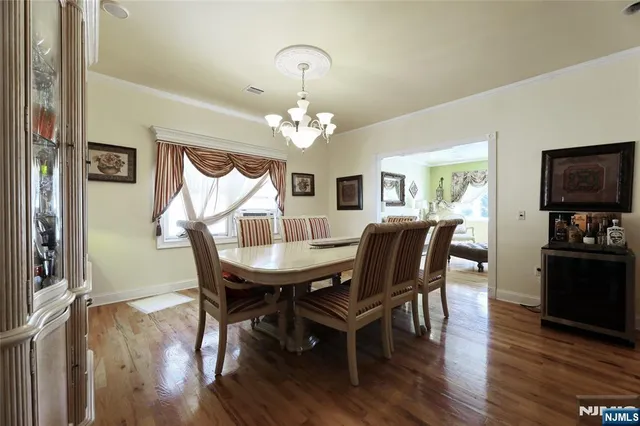 a living room with furniture wooden floor and a chandelier