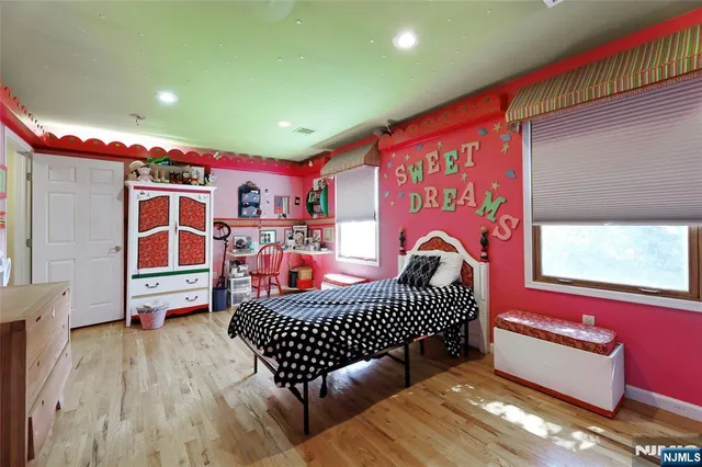 a dining room with furniture a chandelier and wooden floor